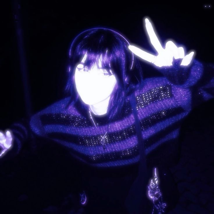 Portrait with headphones and a peace sign in violet light
